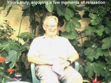 Yours, truly, enjoying a few moments of relaxation  surrounded by his Fig trees. (This must surely be a true Englishman's garden! -- John's comments)